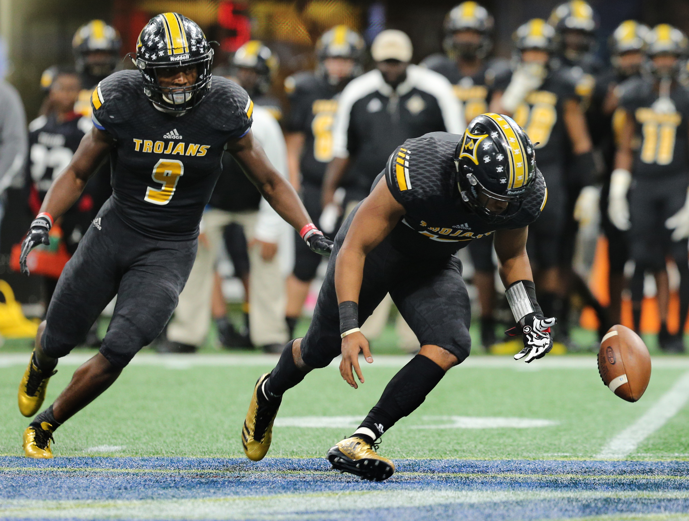 Peach County's Trevon Woolfolk (9) and Antonio Gilbert (12) chase after a Peach County fumble during the Class AAA State Championship football game between Calhoun and Peach County Friday, Dec. 8, 2017 at the Mercedes-Benz Stadium in Atlanta, Ga.