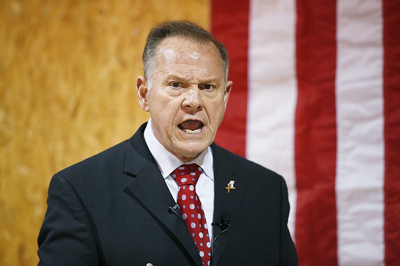 In this Nov. 30, 2017 file photo, former Alabama Chief Justice and U.S. Senate candidate Roy Moore speaks at a campaign rally, in Dora, Ala. In the Alabama Senate race, national Democrats and the liberal grassroots are treading lightly, trying not to sink Doug Jones' upset bid against Republican Roy Moore. (AP Photo/Brynn Anderson, File)