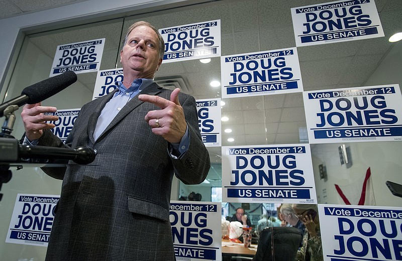 Democratic U.S. Senate candidate Doug Jones talks with the media as he visits his campaign call center in Huntsville, Ala. on Thursday, Dec. 7, 2017. (Mickey Welsh /The Montgomery Advertiser via AP)