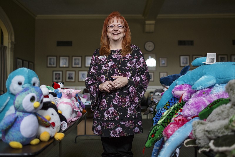 Partnership for Children, Families, and Adults COO Regina McDevitt poses for a portrait with plush toys from the Aquarium's Gifts for Guppies program, one of the services the organization offers for clients around the holidays, in their offices on Friday, Dec. 8, 2017, in Chattanooga, Tenn.