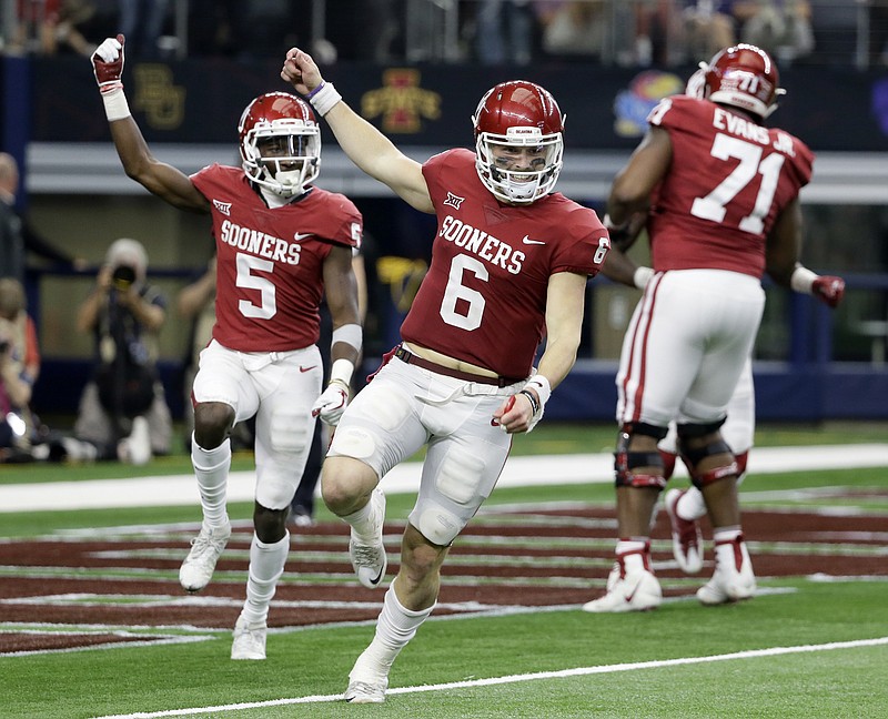 Oklahoma quarterback Baker Mayfield (6) and wide receiver Marquise Brown (5) celebrate hooking up for a long pass and touchdown in the Big 12 Conference championship game against TCU. Mayfield received the 2017 Heisman Trophy on Saturday.