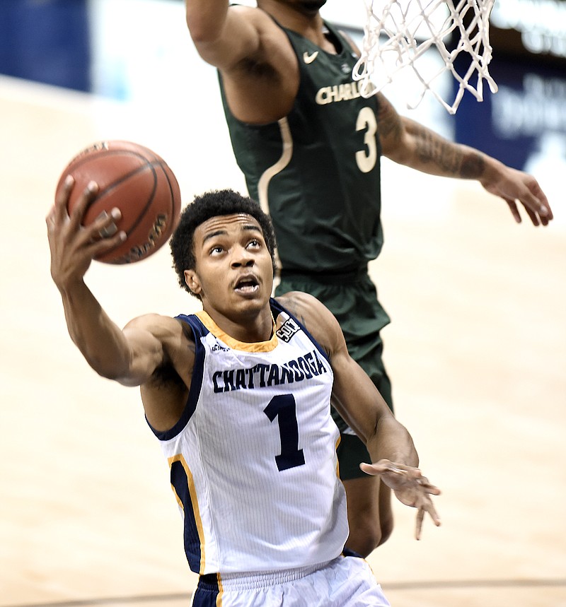 UTC's Rodney Chatman (1) drives past Charlotte's Jon Davis (3) for a layup. The Charlotte 49ers visited the University of Chattanooga at Tennessee Mocs in basketball action at McKenzie Arena on December 10, 2017.