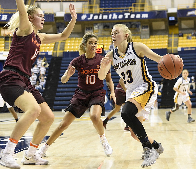 UTC's Lakelyn Bouldin (33) tires to get past's Tech's Regan Magarity (11) and Kendyl Brooks (10).  The Virginia Tech Hokies visited the University of Chattanooga at Tennessee Mocs in women's basketball action at McKenzie Arena on December 10, 2017.