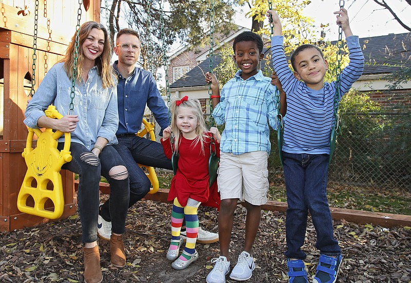 In this Sunday, Dec. 3, 2017, photo, Stephanie and Lance Schmidt pose for a photo with their children, from left, Stella, Solomon and Theo, at their home in Oklahoma City. The Schmidt's have opted for a cost-sharing ministry this year after they realized their monthly insurance bill would have more than doubled to over $1,200 and stuck them with an $8,000 deductible for their family of five. (AP Photo/Sue Ogrocki)