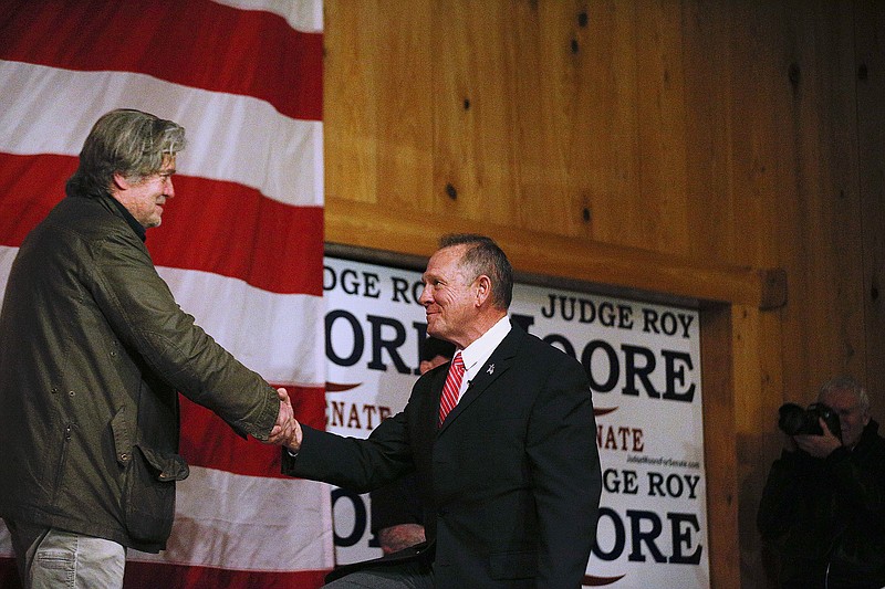 In a Tuesday, Dec. 5, 2017, file photo, Steve Bannon, left, introduces U.S. senatorial candidate Roy Moore, right, during a campaign rally, in Fairhope, Ala. Dogged by allegations of sexual misconduct, Moore has kept to events with limited publicity and shunned contact with the traditional media in the heated race for U.S. Senate. (AP Photo/Brynn Anderson, File)