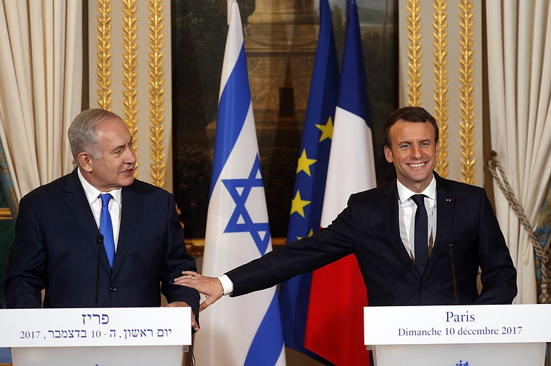 French President Emmanuel Macron, right, and Israeli Prime Minister Benjamin Netanyahu attend a press conference after a meeting at the Elysee Palace in Paris, Sunday, Dec.10, 2017. French President Emmanuel Macron "firmly and clearly" condemns all kinds of attacks against Israel in recent hours and days and reaffirmed his "disapproval" of U.S. President Donald Trump's move to recognize Jerusalem as the capital of Israel. (Philippe Wojazer/Pool via AP)