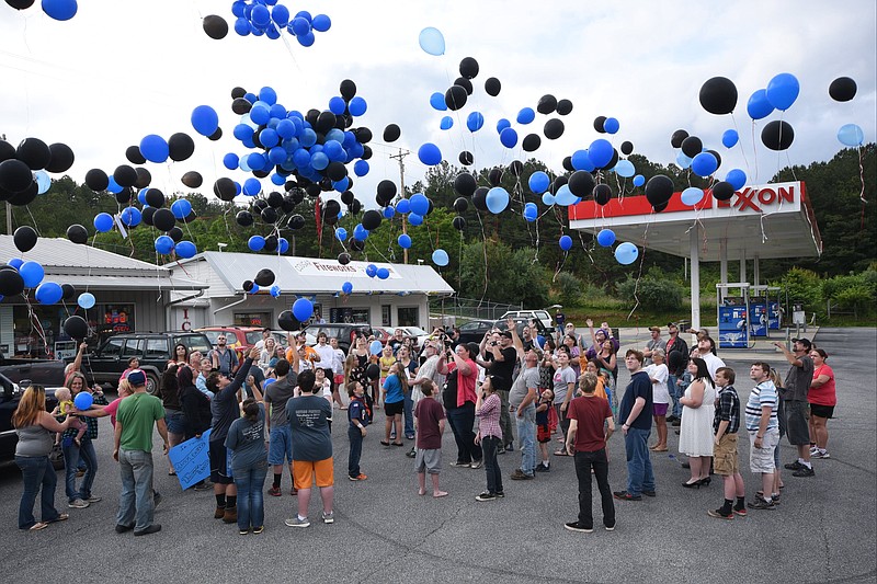 Nearly 100 people release black and blue colored balloons in 2015 in remembrance of two deceased Copper Basin students who were victims of bullying at Copper Basin High School in Polk County.