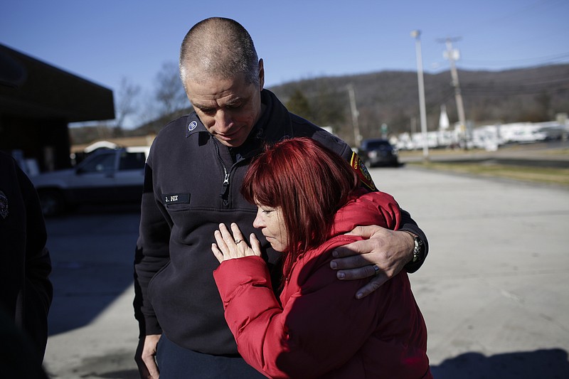 Firefighter Joel Nix comforts Carrie Gann after Gann suffered a panic attack when Chattanooga Fire Station 20's engine had to turn on their sirens and leave to respond to an emergency from Cummings Highway on Saturday, Dec. 9, 2017, in Chattanooga, Tenn. "When I hear sirens, I'm back in that dark room suffocating," Gann says about the attack. When firefighters pulled Gann from the bedroom of her Centro Street home, where she had been trapped by the blaze, on September 20, she was in critical condition, and rescuers were doubtful she would survive. She spent 5 days at Vanderbilt Medical center, but Gann recovered from her ordeal and met with her rescuers Saturday to thank them for saving her life. She says she plans to get a tattoo of the fire house emblem with the names of the three firefighters, Nix, Matt Rorex and Ryan Swisher, who saved her life. Gann says her only lingering regret is the loss of her two dogs in the fire. "My kids have always been four-pawed," she says, because her lifelong diabetes has prevented her from having children.