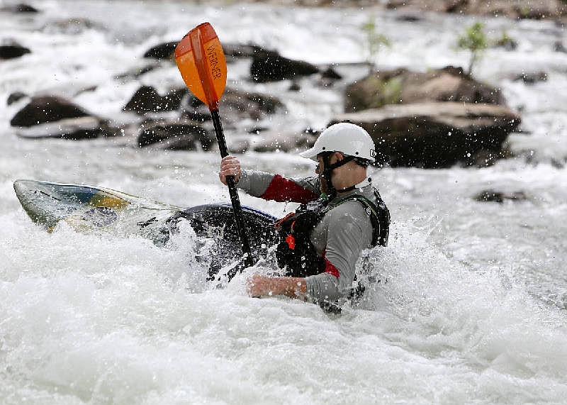 Connor Farrar of Atlanta surfs on a rapid Friday, June 30, 2017, on the Ocoee River in Polk County, Tenn.