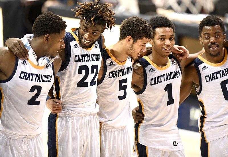 From left, Joshua Phillips, Makinde London, Nat Dixon, Rodney Chatman, and Makale Foreman gather after the win for the alma mater.  The Charlotte 49ers visited the University of Chattanooga at Tennessee Mocs in basketball action at McKenzie Arena on December 10, 2017.