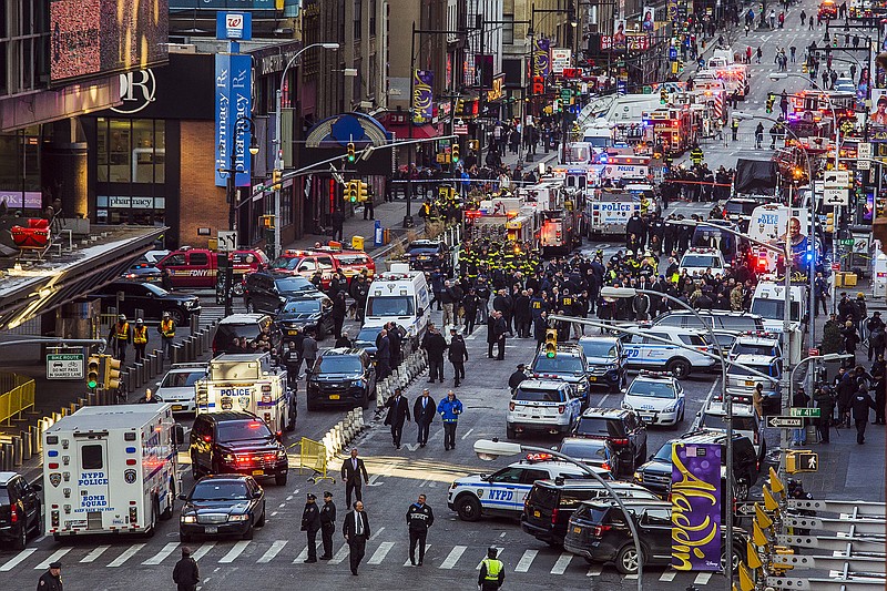 Law enforcement officials work following an explosion near New York's Times Square on Monday, Dec. 11, 2017. Police said a man with a pipe bomb strapped to his body set off the crude device in a passageway under 42nd Street between Seventh and Eighth Avenues. (AP Photo/Andres Kudacki)