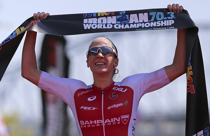 Switzerland's Daniela Ryf celebrates after winning her record third Ironman 70.3 World Championship during the IcyHot Ironman 70.3 World Championship on Saturday, Sept. 9, 2017, in Chattanooga, Tenn.