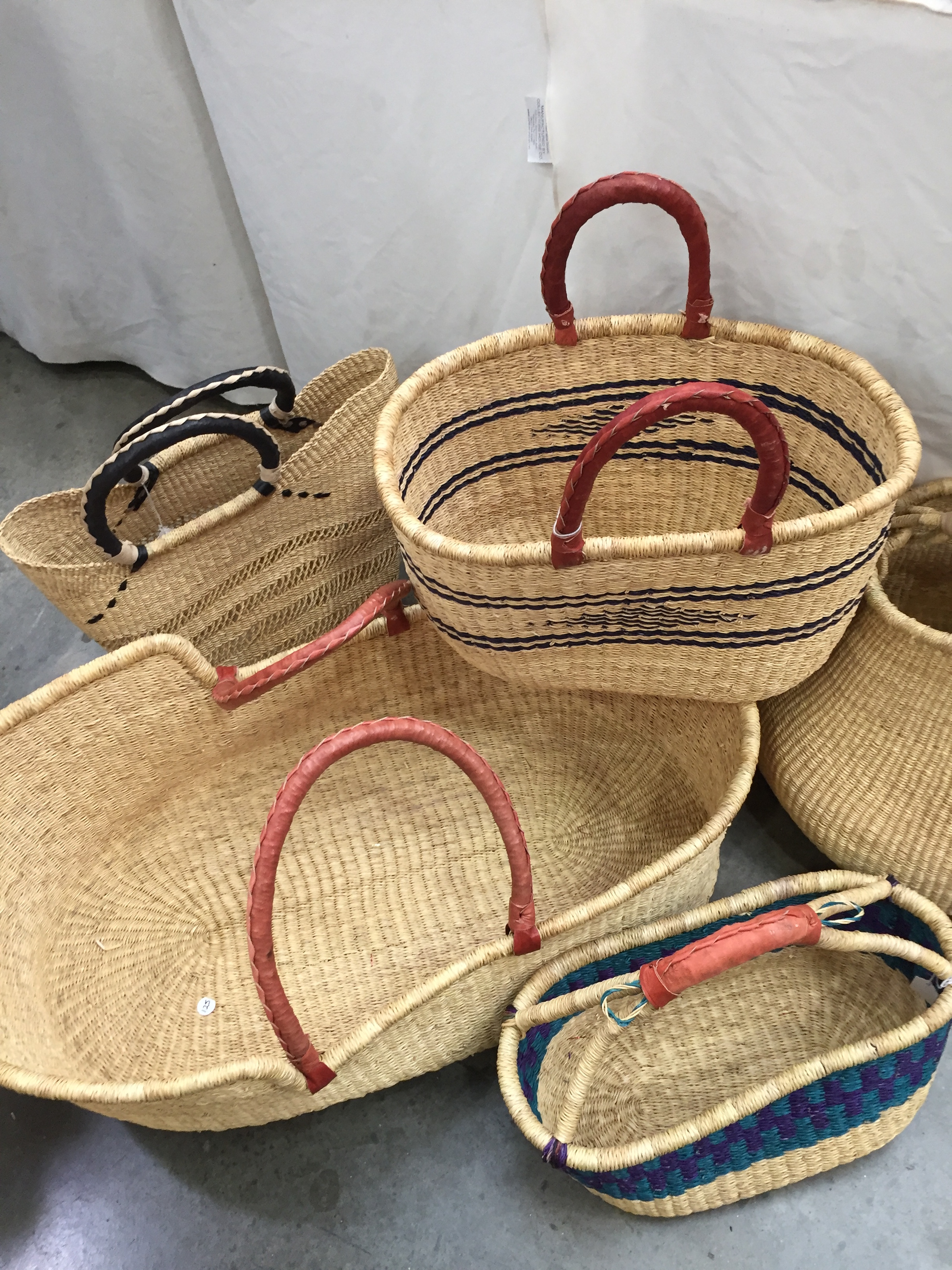 Hand-woven seagrass baskets made by Florence Moses of Savannah, Ga., are as functional as they are decorative. They are easy to clean, fold down for easy storage and carrying, then pop back into shape when unfolded. The multicolor bread basket in front is $48. In back, from left, are a Moses basket, $125; lace basket with black handle, $85.99; oval basket with design, $65.