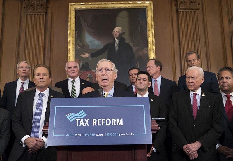 FILE - This Sept. 27, 2017 file photo shows Senate Majority Leader Mitch McConnell, R-Ky., center, joining Speaker of the House Paul Ryan, R-Wis., and other GOP lawmakers to talk about the Republicans' proposed rewrite of the tax code for individuals and corporations, at the Capitol in Washington.