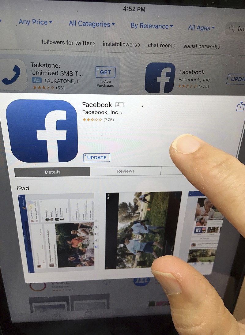 This Monday, June 19, 2017, file photo shows a user about to update Facebook on an iPad, in North Andover, Mass. Several people with tight connections to Facebook, some as early investors, some as former officials, are going public with a critique of the company and social media more broadly. They say Facebook and social media systems undermine democracy and exploit the human psychology to get people addicted to their platforms. In response, Facebook says it is "working hard to improve." (AP Photo/Elise Amendola, File)