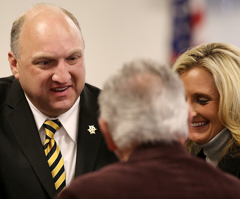 Bradley County Sheriff Eric Watson, left, stops to talk with County Commissioner Howard Thompson as he leaves the courtroom with his wife Tenille Watson, right, after a hearing on a motion to dismiss felony counts against Sheriff Watson on Wednesday, Dec. 13, 2017 in Cleveland, Tenn. Sheriff Watson is being charged with 12 felonies in relation to forged vehicle registrations.