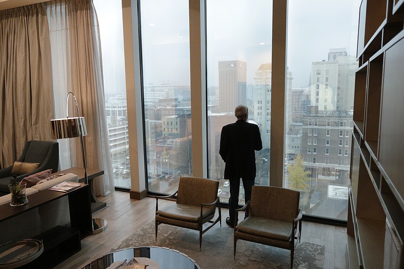 Staff photo by Doug Strickland / Jim Brewer checks out the view from the $2,500 or so per night presidential suite during the grand opening of the new downtown Westin hotel on Nov. 30. The luxury hotel was developed by brothers Byron and Ken DeFoor.