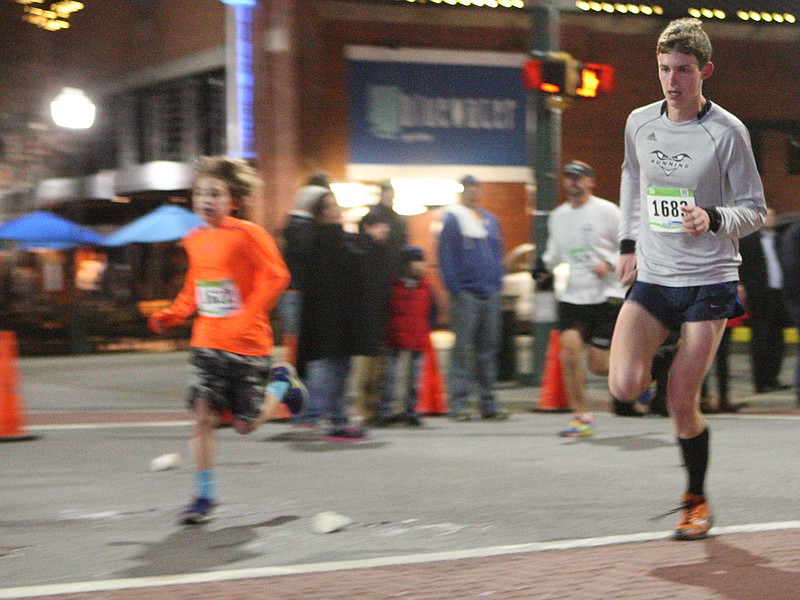 Former UTC runner Paul Stuart, right, nears the finish line in winning the 35th Karen Lawrence Run four years ago in downtown Chattanooga. The 39th version is coming up on New Year's Eve.