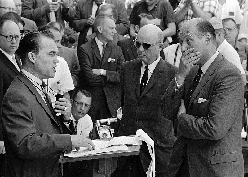 In this June 11, 1963 file photo, Gov. George Wallace carries out his promise to stand in the doorway to prevent integration at the University of Alabama in Tuscaloosa, Ala. At right, Nicholas Katzenbach, deputy attorney general of the United States, listens to Wallace. The wild Senate race between Republican Roy Moore and Democrat Doug Jones is only the latest odd political campaign in Alabama. Wallace won that race in 1962 and later promised "segregation forever" at his inaugural, ushering in a dark period of racial politics. (AP Photo, File)