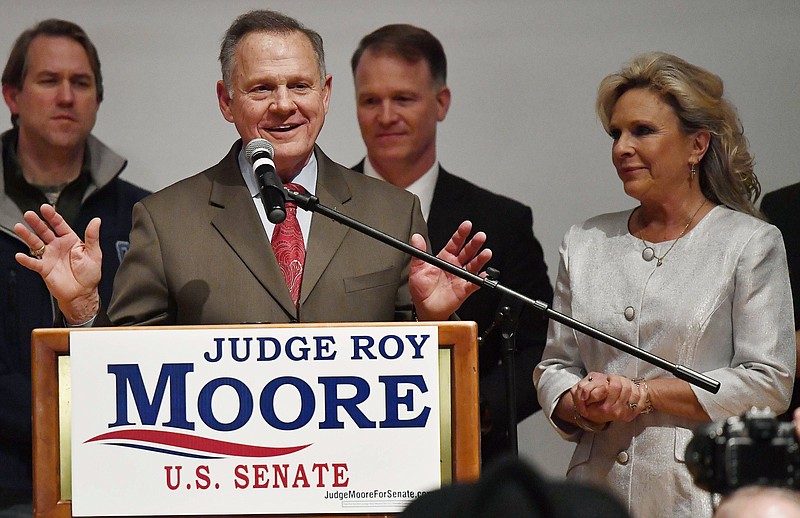 U.S. Senate candidate Roy Moore speaks as his wife Kayla Moore, right, listens at the RSA activity center, Tuesday, Dec. 12, 2017, in Montgomery, Ala. Moore did not concede to his Democratic opponent Doug Jones.(AP Photo/Mike Stewart)