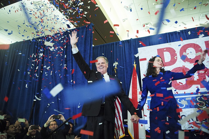 Democrat Doug Jones, the newly elected U.S. Senator from Alabama, on stage with his wife, Louise, celebrates his victory Tuesday during a watch party in Birmingham. (Bob Miller/The New York Times)