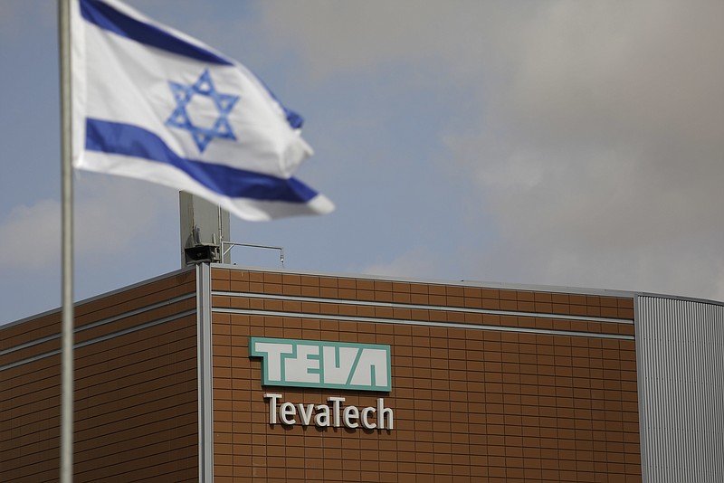 
              Israeli flag flies outside Teva Pharmaceutical facility building in Neot Hovav, Israel, Thursday, Dec. 14, 2017. Teva Pharmaceutical Industries Ltd., the world's largest generic drugmaker, says it is laying off 14,000 workers as part of a global restructuring. The company said Thursday that the layoffs represent over 25 percent of its global work force. (AP Photo/Tsafrir Abayov)
            