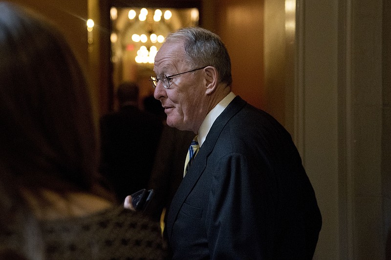 Sen. Lamar Alexander, R-Tenn., arrives as Republican senators gather to meet with Senate Majority Leader Mitch McConnell, R-Ky., on the GOP effort to overhaul the tax code, on Capitol Hill, Friday, Dec. 1, 2017, in Washington. (AP Photo/Andrew Harnik)
