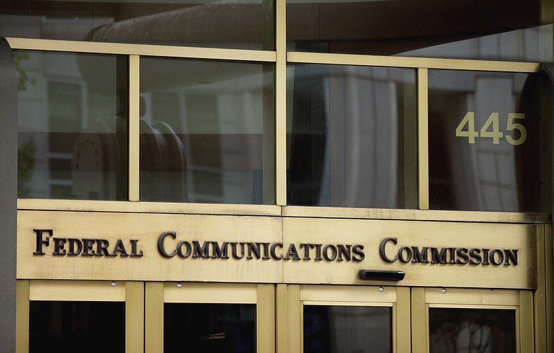 This June 19, 2015, file photo, shows the entrance to the Federal Communications Commission (FCC) building in Washington. "Net neutrality" regulations, designed to prevent internet service providers like Verizon, AT&T, Comcast and Charter from favoring some sites and apps over others, are on the chopping block. Federal Communications Commission Chairman Ajit Pai, a Republican, on Tuesday, Dec. 12, 2017, unveiled a plan to undo the Obama-era rules that have been in place since 2015. (AP Photo/Andrew Harnik, File)