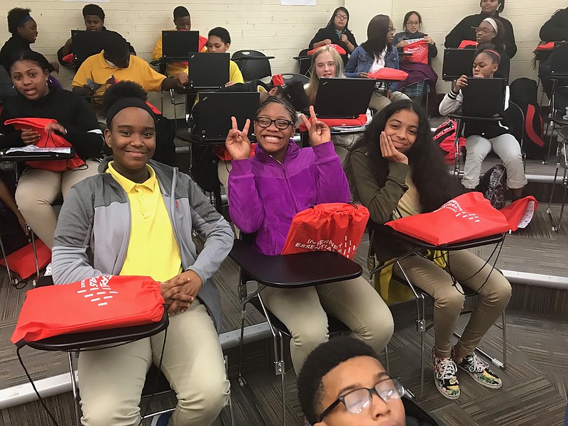 Students at Chattanooga Girls Leadership Academy celebrate after Comcast gave 25 students free computers. The CGLA students are among 50 recipients today of laptops Comcast donated in Chattanooga to low-income persons needing a computer for internet access.