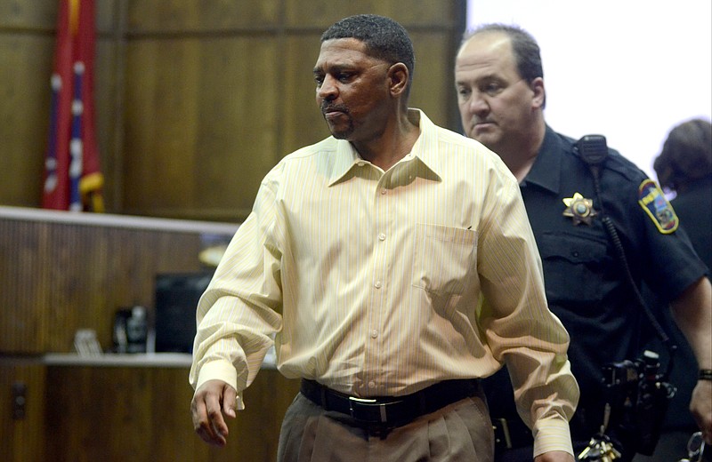 Accompanied by court officer Tim Higgs, right, defendant Tony Bigoms enters Judge Barry Steelman's courtroom during the first day of testimony in his murder trial. Bigoms is accused in the 2012 slaying of Dana Wilkes.