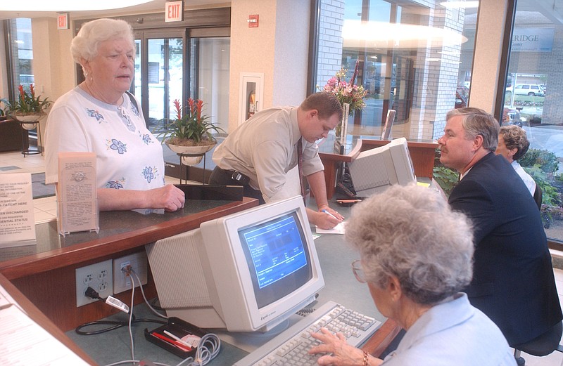 In this 2003 staff file photo, volunteer Betty Lucas, right, answers questions for Joyce Jackson at the Parkridge Medical Center information desk.