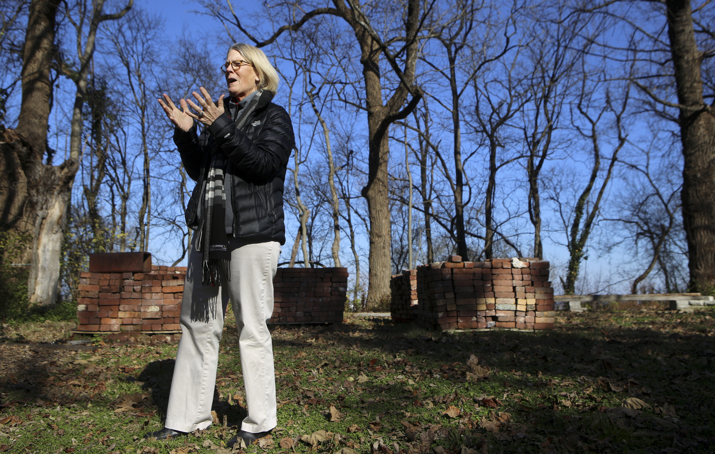 Lookout Mountain Conservancy Executive Director Robyn Carlton talks while touring the location of the old Scholze mansion off of Old Wauhatchie Pike on Thursday, Dec. 14, 2017 in Chattanooga, Tenn. Stacked behind Carlton are some of the 36,000 bricks recovered from the property. The Lookout Mountain Conservancy plans to create a conservation-themed neighborhood of 24 homes on 3.5 acres at the site of the old Scholze home place.