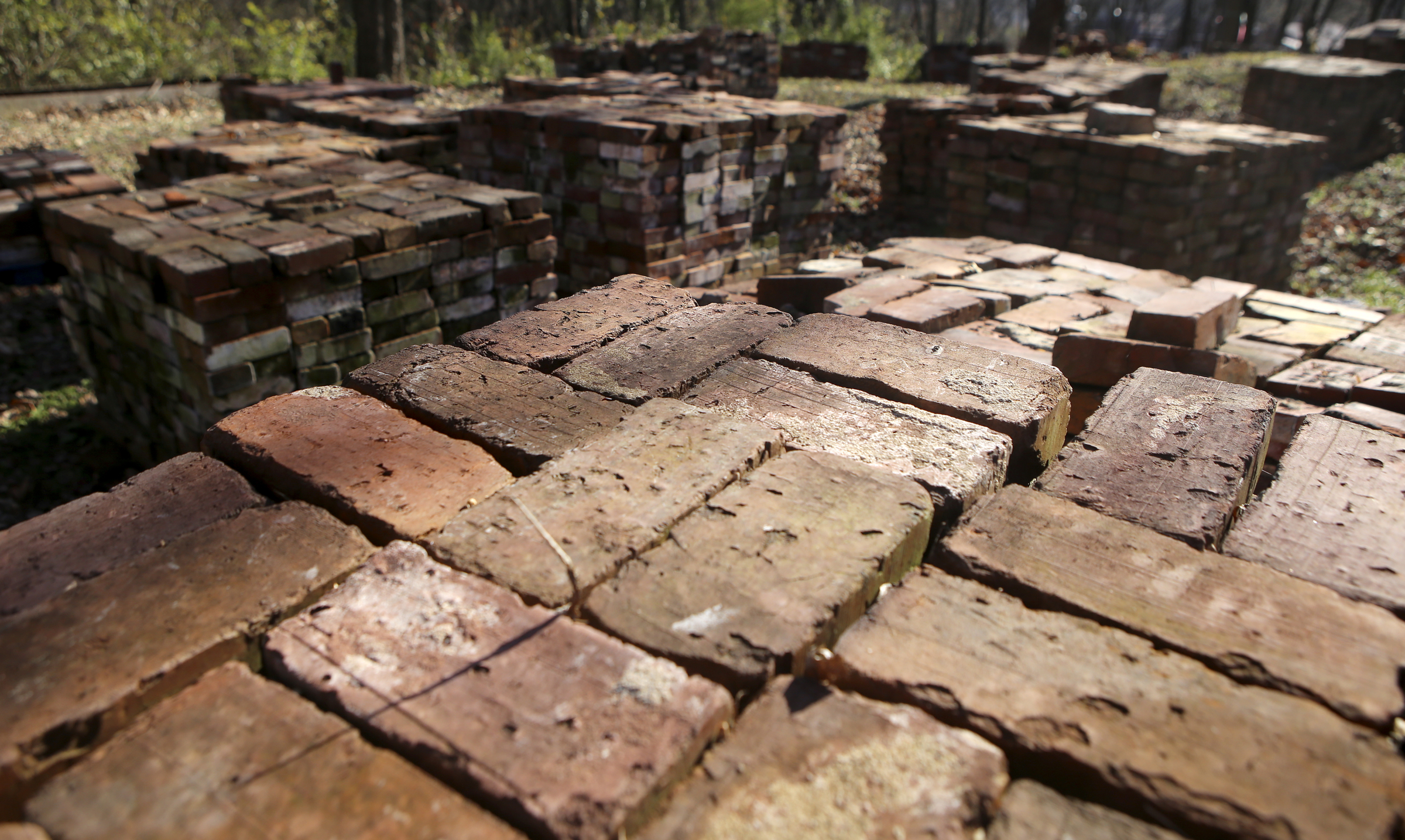 Stacks of recovered bricks, to be repurposed, are stacked at the site of the old Scholze mansion off of Old Wauhatchie Pike on Thursday, Dec. 14, 2017 in Chattanooga, Tenn. Interns from The Howard School have cleaned and stacked 36,000 bricks. The Lookout Mountain Conservancy plans to create a conservation-themed neighborhood of 24 homes on 3.5 acres at the site of the old Scholze home place.