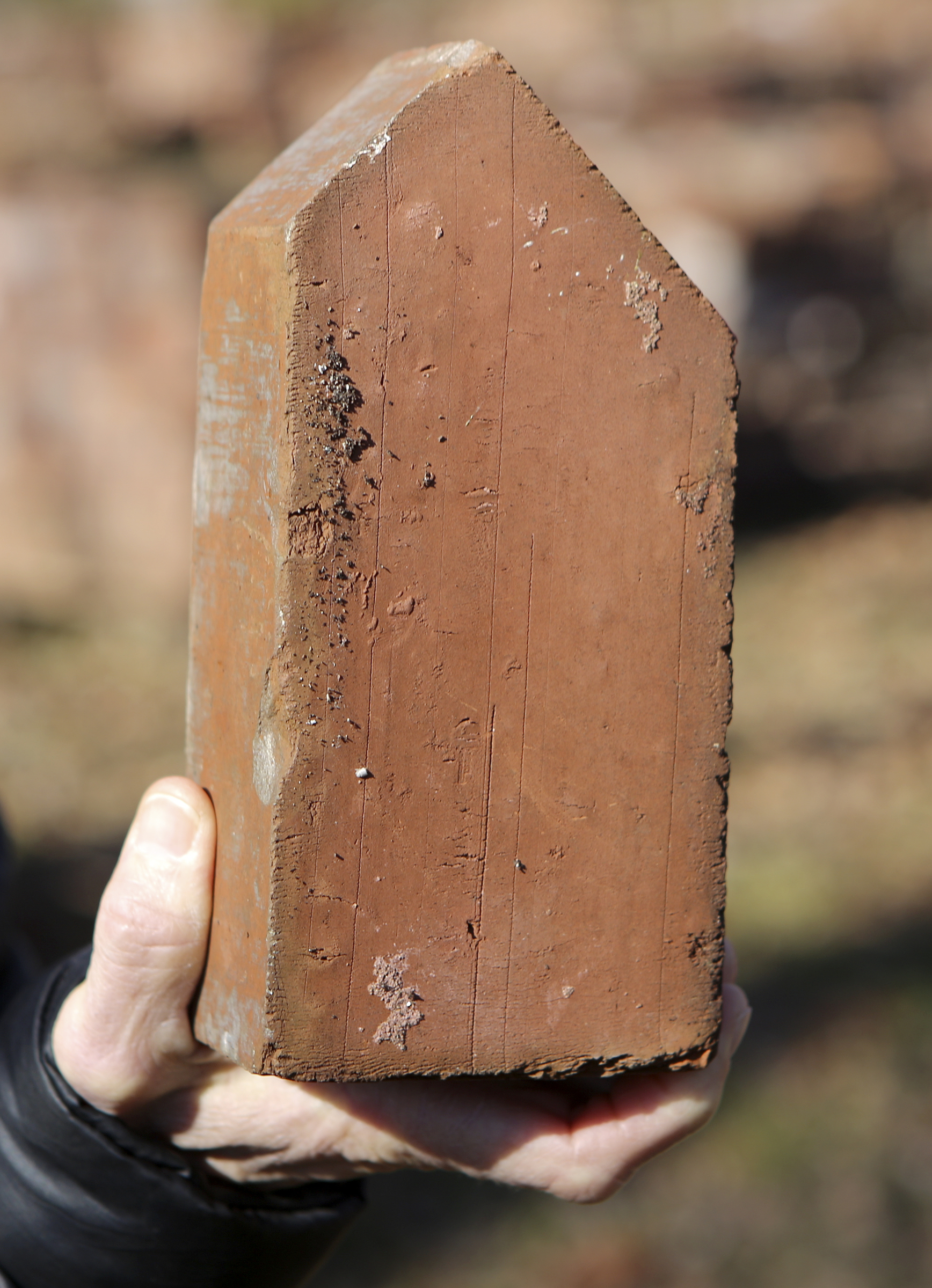 Lookout Mountain Conservancy Executive Director Robyn Carlton holds a corner brick from the site of the former Scholze mansion off of Old Wauhatchie Pike on Thursday, Dec. 14, 2017 in Chattanooga, Tenn. The Lookout Mountain Conservancy plans to create a conservation-themed neighborhood of 24 homes on 3.5 acres at the site of the old Scholze home place.