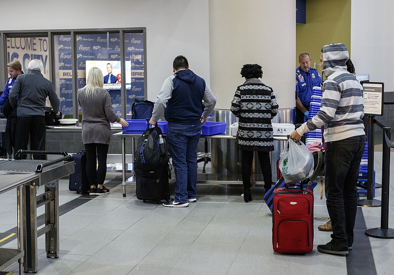 Travelers walk to the security checkpoint while traveling through the Chattanooga Metropolitan Airport on Friday, Dec. 15, 2017, in Chattanooga, Tenn. AAA forecasts a 3.1% increase in holiday travel over last year with an estimated 103 million Americans traveling between Dec. 23rd and Jan. 1st.