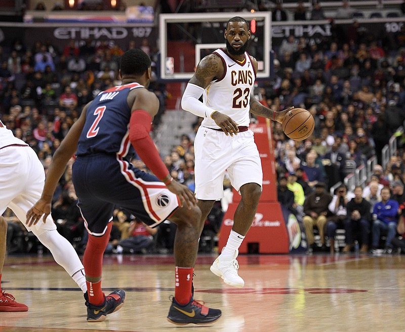 
              Cleveland Cavaliers forward LeBron James (23) dribbles against Washington Wizards guard John Wall (2) during the first half of an NBA basketball game, Sunday, Dec. 17, 2017, in Washington. (AP Photo/Nick Wass)
            