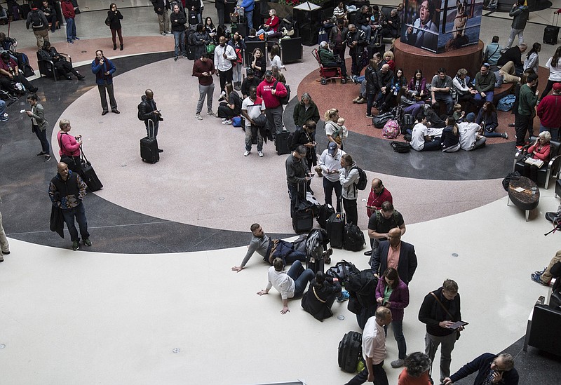 Long lines form at Hartsfield-Jackson International Airport after a power outage, Sunday, Dec. 17, 2017, in Atlanta. A sudden power outage at the Hartsfield-Jackson Atlanta International Airport on Sunday grounded scores of flights and passengers during one of the busiest travel times of the year. (Steve Schaefer/Atlanta Journal-Constitution via AP)