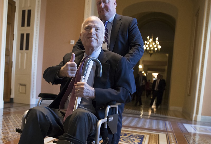 n this Dec. 1, 2017 file photo, Sen. John McCain, R-Ariz., leaves a closed-door session where Republican senators met on the GOP effort to overhaul the tax code, on Capitol Hill in Washington. President Donald Trump says McCain is returning home to Arizona after being hospitalized over the side effects from his brain cancer treatment. The 81-year-old McCain has been hospitalized at Walter Reed Medical Center in Maryland. (AP Photo/J. Scott Applewhite, File)
