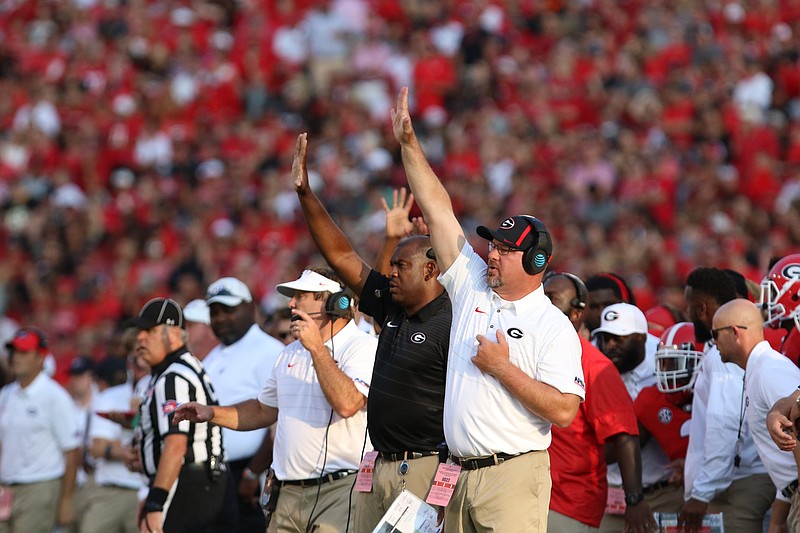 Georgia outside linebackers coach Kevin Sherrer, right, signals instructions from the sideline alongside defensive coordinator Mel Tucker, center, and head coach Kirby Smart, left, during the season opener against Appalachian State. Sherrer will coach with the Bulldogs through the playoff before leaving to join Jeremy Pruitt's staff at Tennessee.