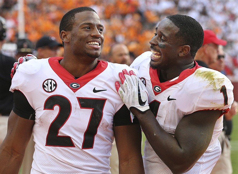 
              FILE - In this Sept. 30, 2017, file photo, Georgia tailbacks Nick Chubb, left, and Sony Michel celebrate on the sidelines during the fourth quarter of a 41-0 shut out over Tennessee in a NCAA college football game, in Knoxville. It's difficult to imagine Rose Bowl-bound Georgia being one of the final four teams competing for the national championship if not for the decisions by tailbacks Nick Chubb and Sony Michel to return for their senior seasons. The SEC championship and spot in the College Football Playoff is exactly what they hoped to accomplish. B (Curtis Compton/Atlanta Journal-Constitution via AP, File)
            