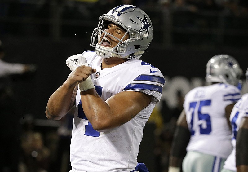 Dallas Cowboys quarterback Dak Prescott (4) celebrates after scoring a touchdown against the Oakland Raiders during the second half of an NFL football game in Oakland, Calif., Sunday, Dec. 17, 2017. (AP Photo/Eric Risberg)