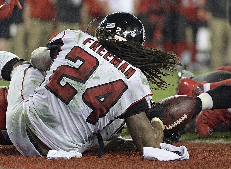 Atlanta Falcons running back Devonta Freeman (24) fumbles the ball in the end zone and it was recovered by Falcons tight end Levine Toilolo for a touchdown during the first half of an NFL football game against the Tampa Bay Buccaneers, Monday, Dec. 18, 2017, in Tampa, Fla. (AP Photo/Phelan M. Ebenhack)