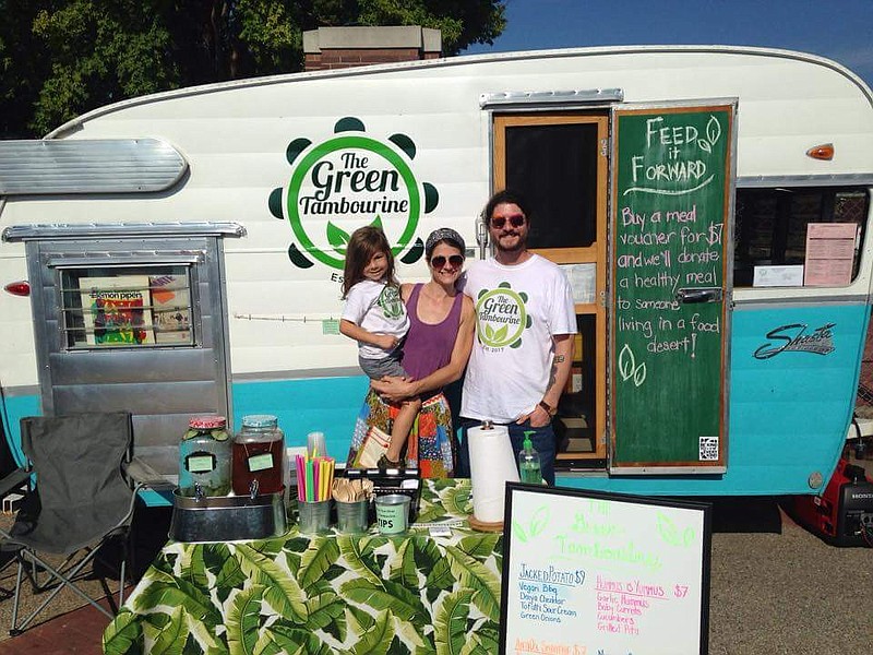 Chelsey Breedy-Oyer stands in front of her vegan food truck, The Green Tambourine, with son Ezra and husband Ryan. (Contributed photo)