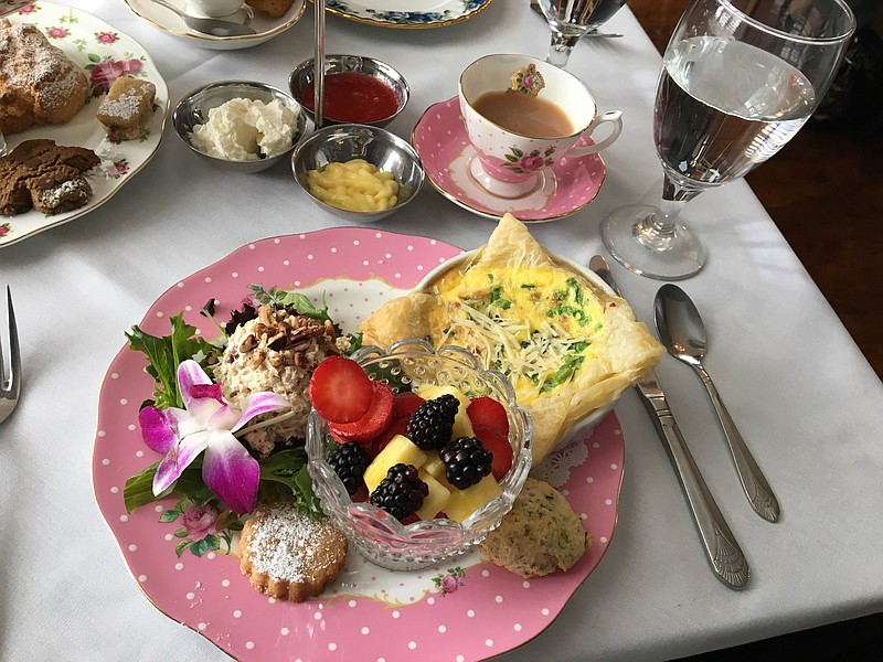 The brunch plate at Polly Claire's is served with chicken salad phyllo cup, fruit, quiche, a savory scone bite and buttered round.