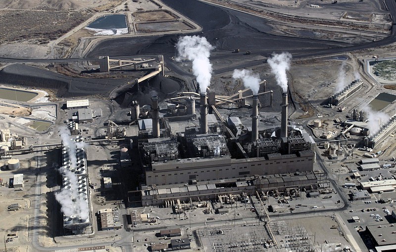 FILE - This Nov. 9, 2009, file photo shows the coal-fired San Juan Generating Station near Farmington, N.M. The first of two units to be shut down at the coal-fired power plant that has served customers throughout the American Southwest for decades is no longer in operation. Officials with New Mexico's largest electric utility say Unit 3 at the San Juan Generating Station was switched off just after midnight on Dec. 19, 2017, and the other unit will be turned off this weekend as Public Service Co. of New Mexico looks to meet a federally-mandated deadline. (AP Photo/Susan Montoya Bryan, File)