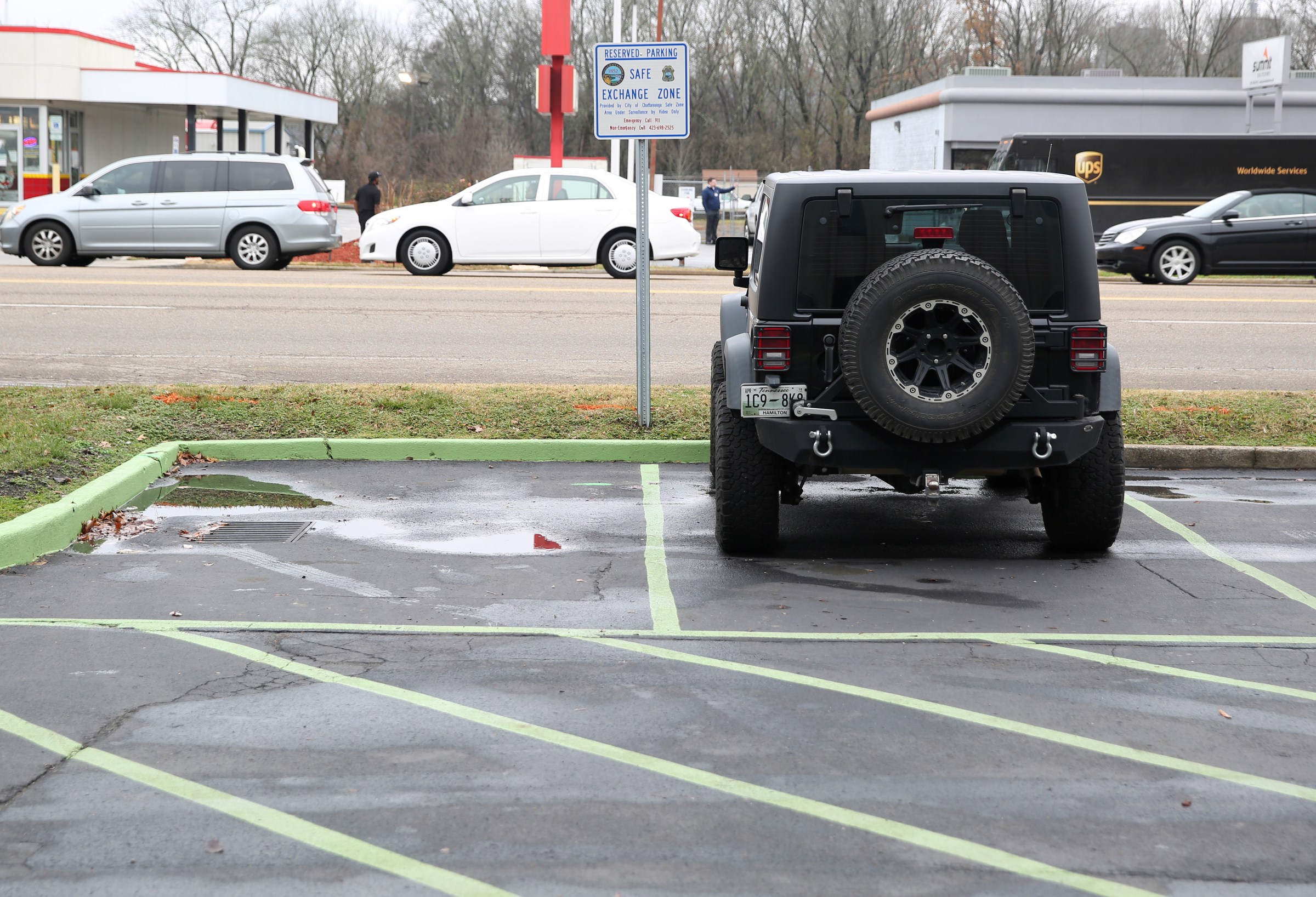 Two parking spaces deemed a Safe Exchange Zone are marked off with green paint Wednesday, Dec. 20, 2017 in front of the Police Service Center in Chattanooga, Tenn. The Chattanooga Police Department has established a Safe Exchange Zone in the parking lot in front of the Police Service Center on Amnicola Highway, so people who are buying or selling items online have a safe location to meet and exchange money for goods.