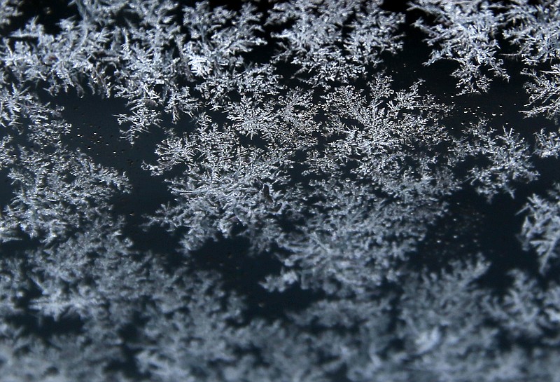 
              FILE - In this Tuesday, April 5, 2016 file photo, snowflakes stick to a car window in Brookfield, Wis. To form ice that creates snowflakes, moisture high in the atmosphere clings to particles that may include dust specks and or pollen. Add germs to that list. University of Florida microbiologist Brent Christner has found that bacteria from plants are surprisingly common ice "nucleators" _ in populated areas, barren mountain peaks and even Antarctica. (AP Photo/Nam Y. Huh)
            