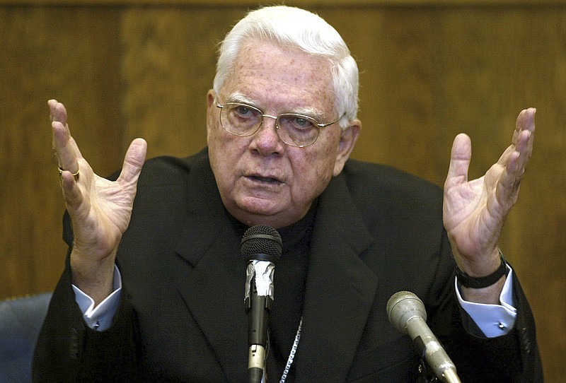 In this Aug. 2, 2002 file photo, Cardinal Bernard Law, of the Boston archdiocese of the Roman Catholic Church, testifies in Suffolk Superior Court in Boston. Law was answering questions about his knowledge and handling of the Father John Geoghan child sex abuse case. An official with the Catholic Church said Tuesday, Dec. 19, 2017, that Cardinal Bernard Law, the disgraced former archbishop of Boston, has died at 86. Law recently had been hospitalized in Rome.  (George Martell/Boston Herald via AP, Pool, File)