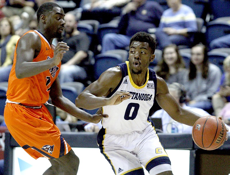 Chattanooga's Makale Foreman (0) drives to the basket against UT Martin's Darius Thompson (11) on Saturday. The Chattanooga Mocs took on the UT Martin Skyhawks at McKenzie Arena in Chattanooga, Tenn. on Saturday Dec. 2, 2017. (Photo: Bryant Hawkins/University of Tennessee)