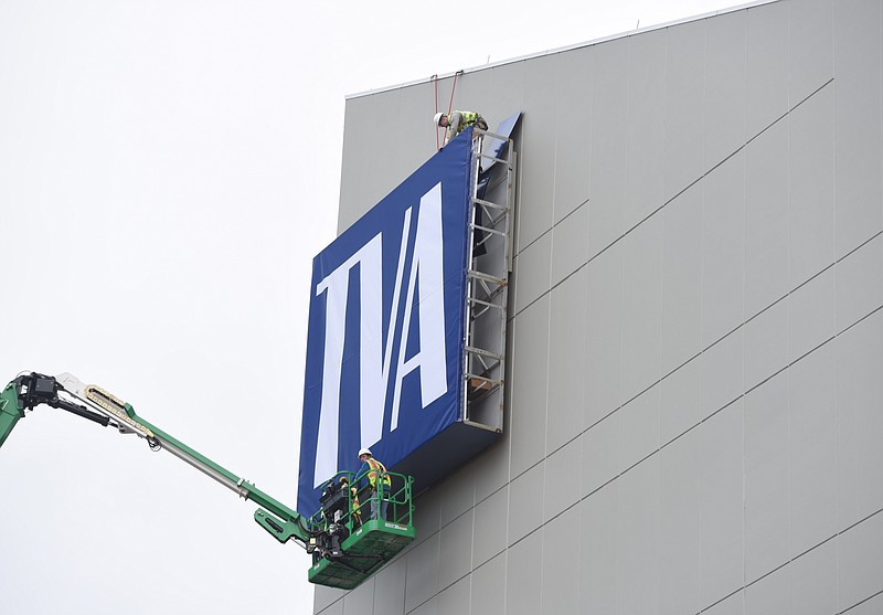 Workers install a new, 19-foot-high TVA sign Thursday, Dec. 21, 2017, on the Lookout Place building at the Tennessee Valley Authority complex in downtown Chattanooga.